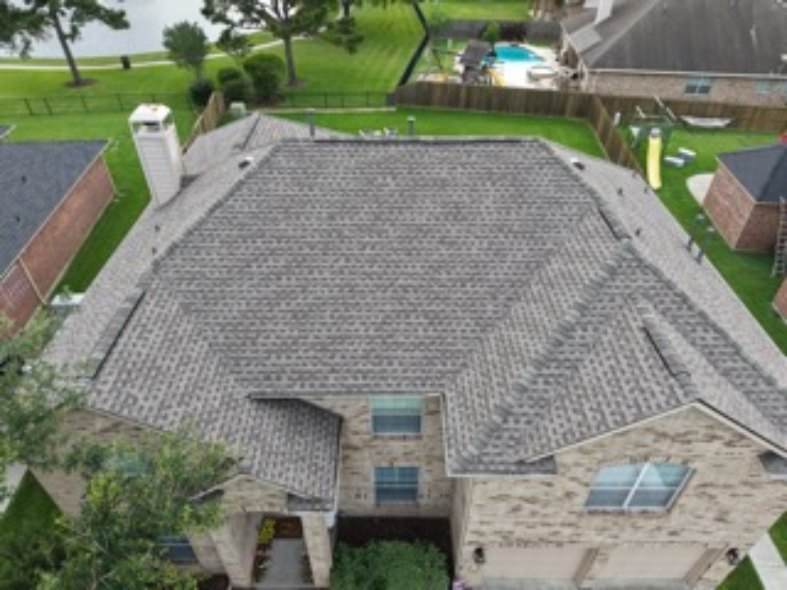 A finished residential shingle roof photographed above the home
